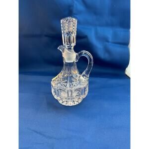Vintage 1920s clear glass cruet with a stopper, likely used for oil or vinegar